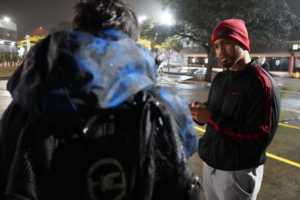 A volunteer talks with someone experiencing homelessness and records their info on his phone during the 2023 PIT Count